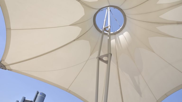 One of the permanent tents of the Riverwalk in downtown Detroit Michigan. Renaissance Center present in the background. The Riverwalk is the refurbished river front area with parks and entertainment. Part of Detroit's urban renewal effort.